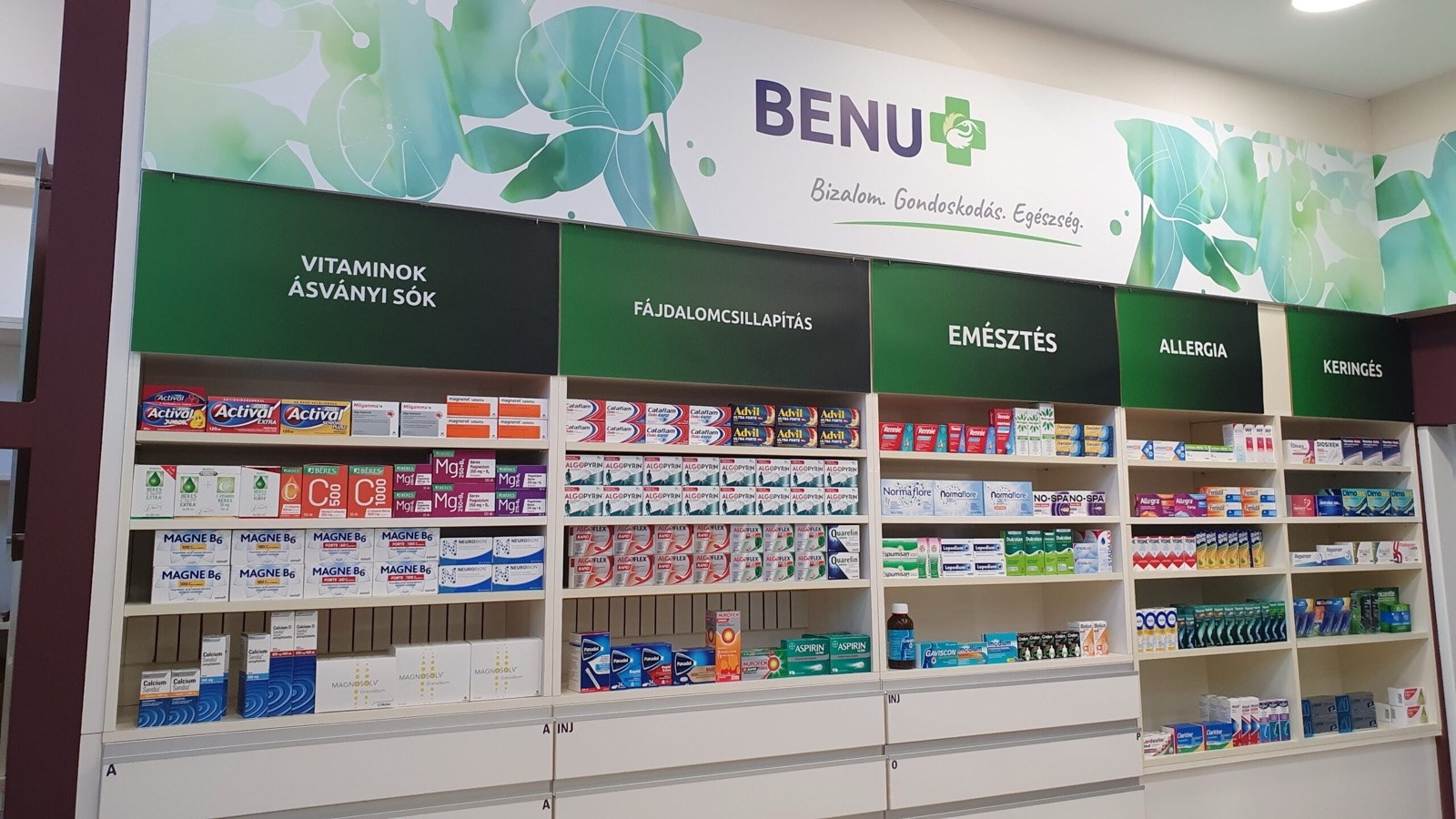 The interior of Kantharosz Gyógyszertár, with neatly arranged product shelving